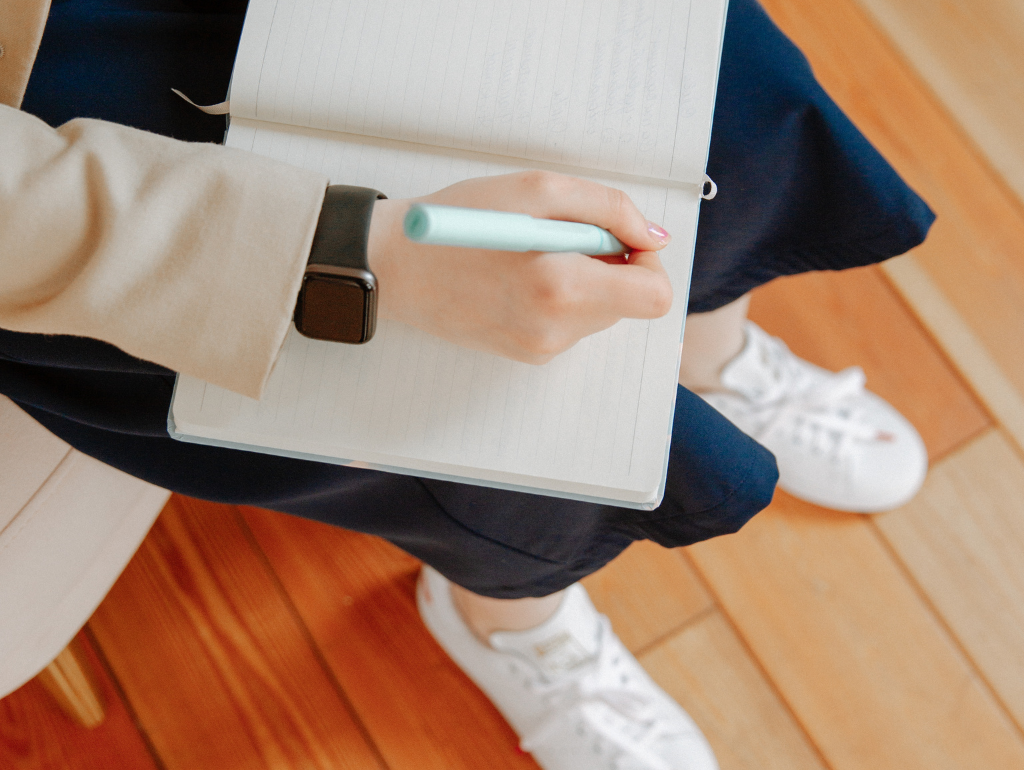 Person taking notes in a notebook